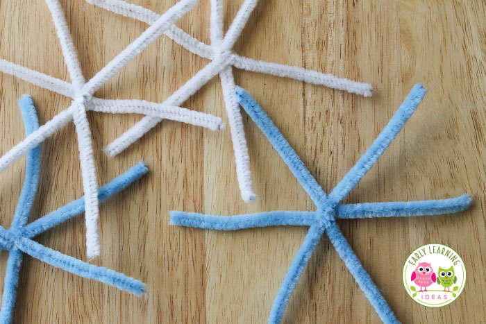Your kids are ready to add beads to your snowflake craft activity.  