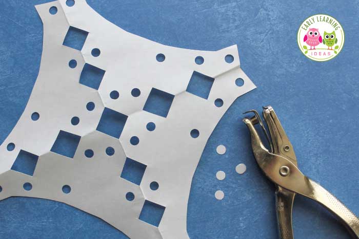 Kids love using a hole punch for your snowflake craft ideas