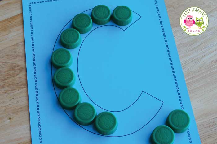 Trace letters with your plastic bottle caps.