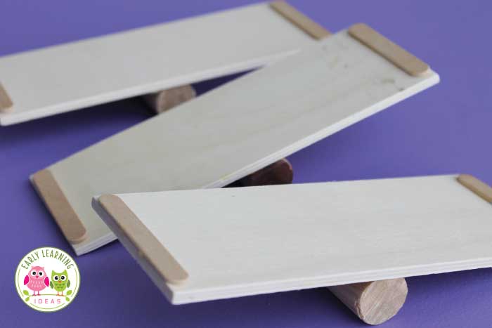 Learn how to make a DIY balance for kids with a few simple and inexpensive materials from the craft store. The balances are great for math, science, or STEM learning centers in your preschool or pre-k classroom. The fun ramps and balances are perfect for small group and independent activities. Use in math centers or math workstations...or in a sensory table or sensory bin. Your kids will love learning with these preschool weight and measurement activities. #preschoolstem #preschool
