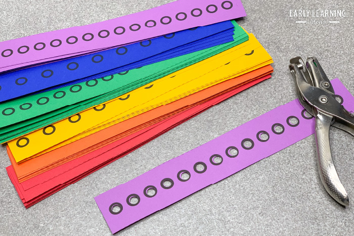 a good example of fun hole punch activities - an image of hole punch strips with a paper punch..  A paper chain.
