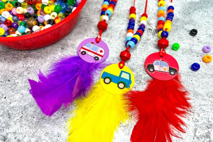 beaded necklaces with cars and trucks on them to show how one of the benefits of crafts for preschoolers is building hand-eye coordination.