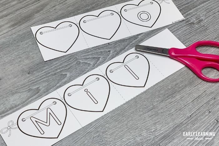 cutting apart a heart name puzzle for preschoolers