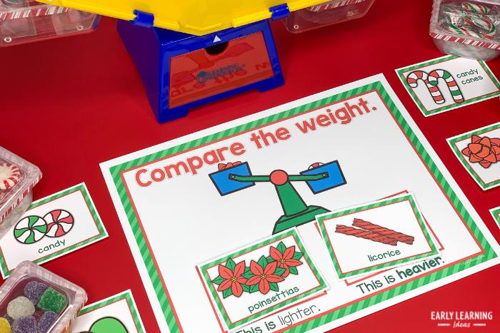 Christmas science activities for preschoolers - a Christmas-themed weight activity with a balance scale and holiday themed items to weigh