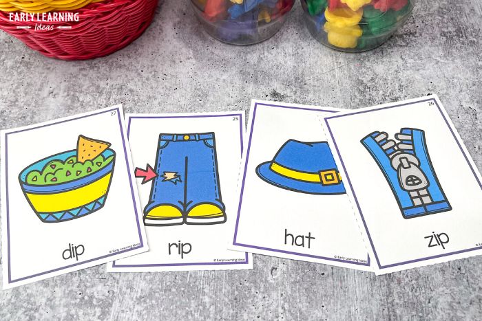 Kid eliminate the word that does not rhyme in this rhyming exercise.  The cards illustrate the words dip, rip, zip, and hat.