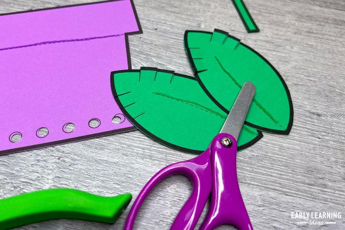 cutting and snipping practice with a seedling Earth Day fine motor activity and Earth Day crafts for preschoolers.