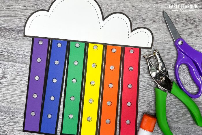 a printable rainbow craft with a hole punch, scissors, and a glue stick. This is an example of the benefits of crafts for preschoolers and a weather activity idea.