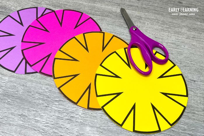 Printable flower craft for preschoolers cut out with a pair of scissors.  This is an example of an activity to improve cutting skills.