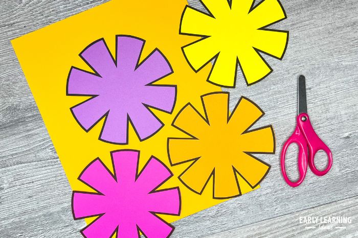 Paper flowers from a free printable flower craft for preschoolers - an example of how to improve cutting skills.