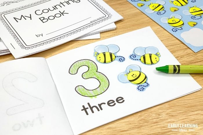 Printable number books for preschoolers.  This book is open to the number 3 page and a child has added 3 bumblebee stickers to the page.
