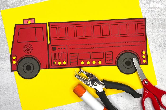 a cut and paste fire truck craft and fine motor activity - an example of community helper crafts for kids.
