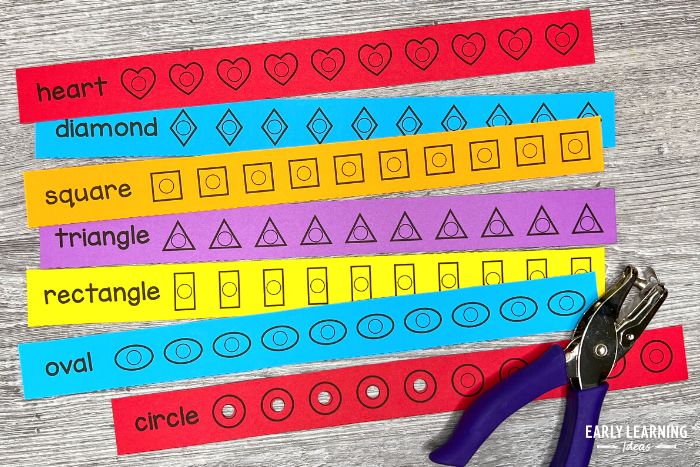 shape hole punch strips with a hole puncher.  The shapes on the strips include circle, oval, rectangle, triangle, square, diamond, and heart on brightly colored paper.