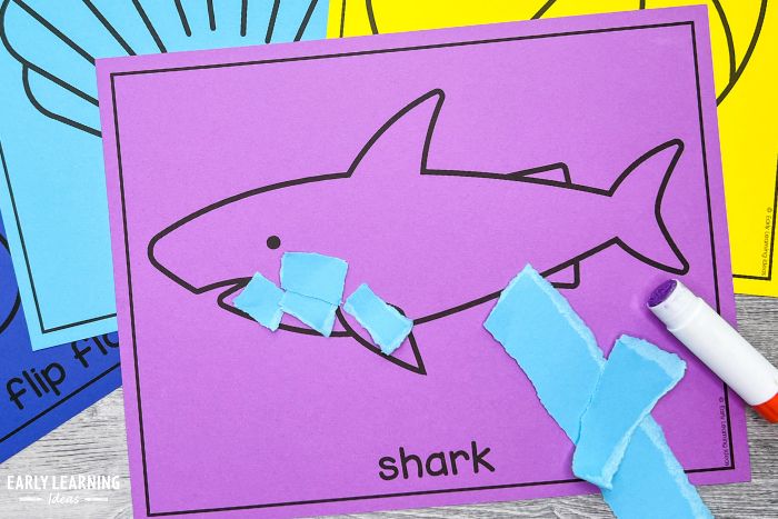 shark craft made with torn paper is an example of ocean theme crafts for preschoolers
