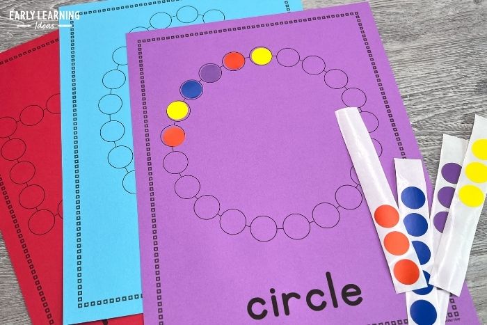 A printable dot sticker worksheet with a circle.  A child has started applying red, blue, purple, and yellow stickers to the perimeter of the circle.  An example of dot sticker activities for kids.