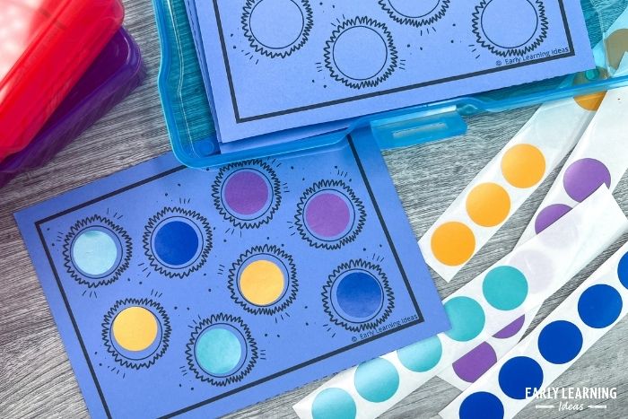blue dot sticker task cards with a variety of colorful dot stickers - an example of dot sticker activities for fine motor skills