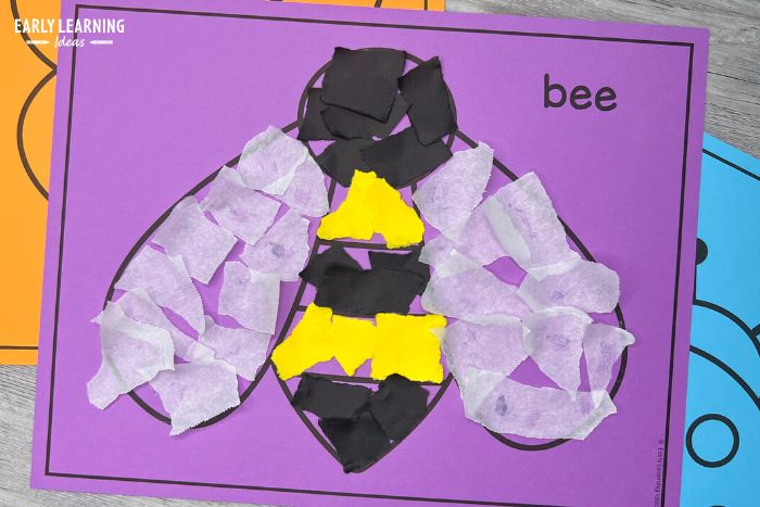 bumble bee torn paper craft to build fine motor skills. The bee is on purple background and includes wings made from torn parchment paper. - an example of bug and insect activities for preschoolers