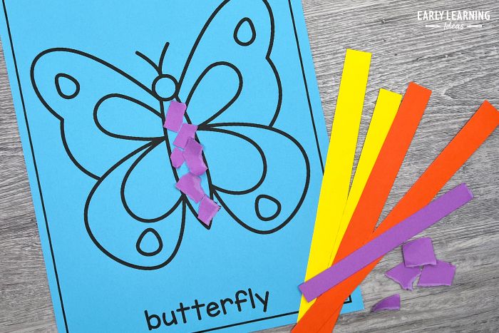 paper tearing butterfly craft with small strips of yellow, orange, and purple paper.  This is an example of paper tearing craft ideas for preschool and kindergarten.