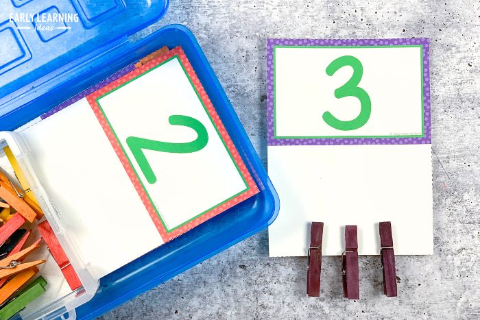 a number 2 and number 3 printable counting clip cards activity with wooden clothespin clips attached to the card.