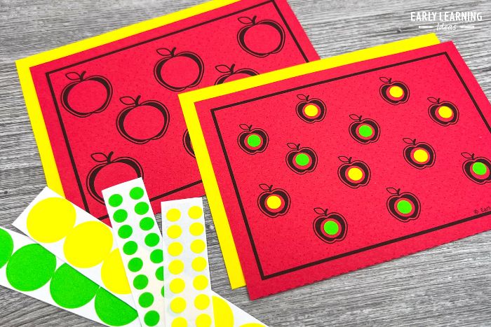 dot sticker fine motor task cards - Two versions of apple fine motor task cards printed on red paper with large and small dot stickers
