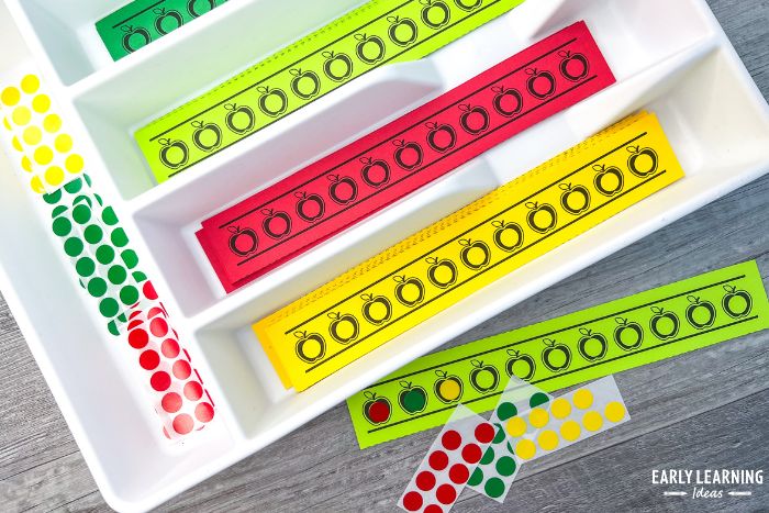 small apple dot sticker printables in a utensil tray with dot stickers