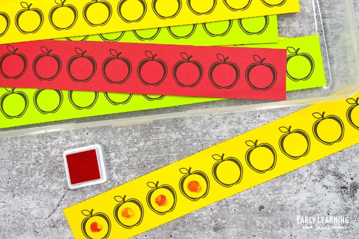 yellow, green, and red dot sticker printables with a red stamp pad and fingerprints on the printables