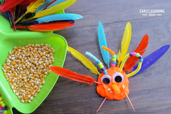 turkey made from playdough, feathers, beads, googly eyes, popcorn and toothpicks