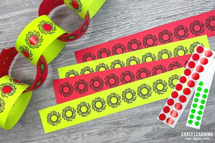 dot sticker printable Christmas fine motor activity -  Stickers are added to the red and green strips and they are taped together to make a paper chain.