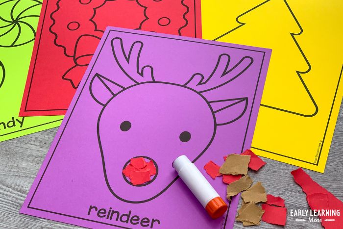 reindeer paper tearing activity printed on purple paper shown with bit of red paper and a glue stick - an example of a Christmas fine motor activity for kids