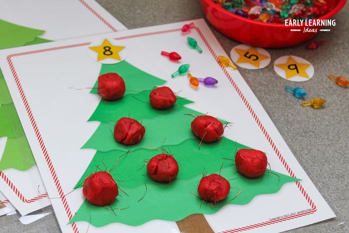 Add the sparkly threads into your Christmas playdough mat.  A Christmas tree playdough mat with a number 8 star and eight balls of red playdough.