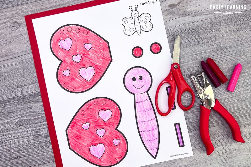 printable love bug craft template.  A no-prep one-page option shown with scissors, crayons, and a hole punch.

