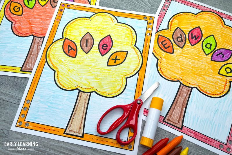 Fall name craft activity for preschoolers. A printable fall tree has been colored yellow and colorful leaves to spell the name Alex have been pasted to the tree.