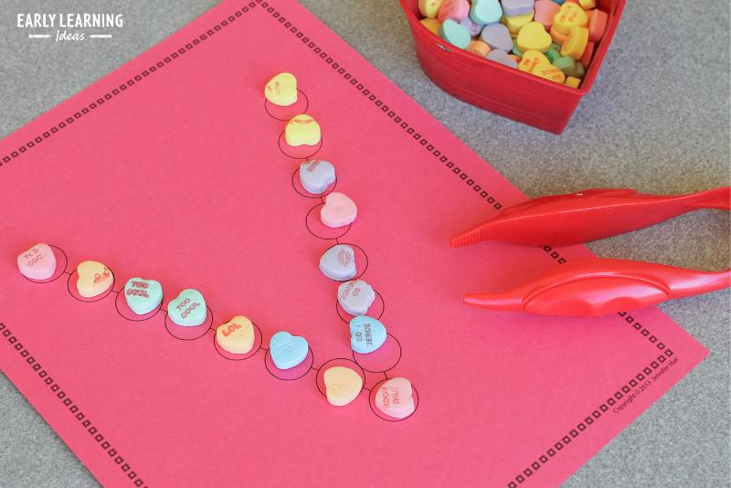 Children used tweezers to place conversation hearts on the letter V.