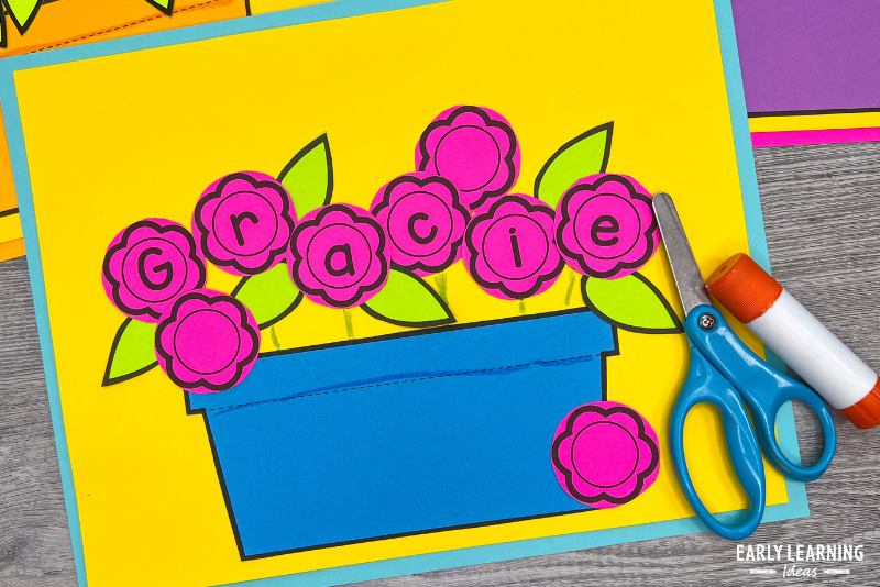 flower name craft printed on bright colored paper shown with scissors and a glue stick.