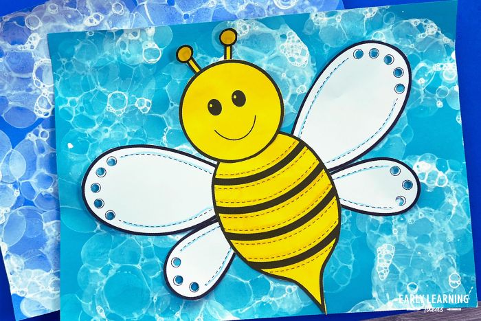 a bumble bee craft on a bubble painted background