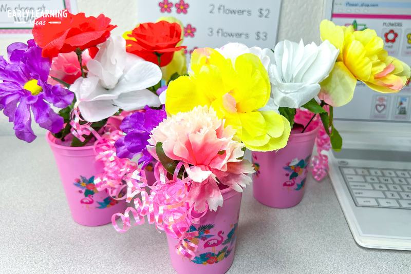 bouquets made with sild flowers stuck in plastic vases for a flower shop dramatic play center.