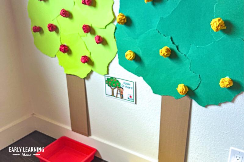 apple orchard made with paper trees on a wall