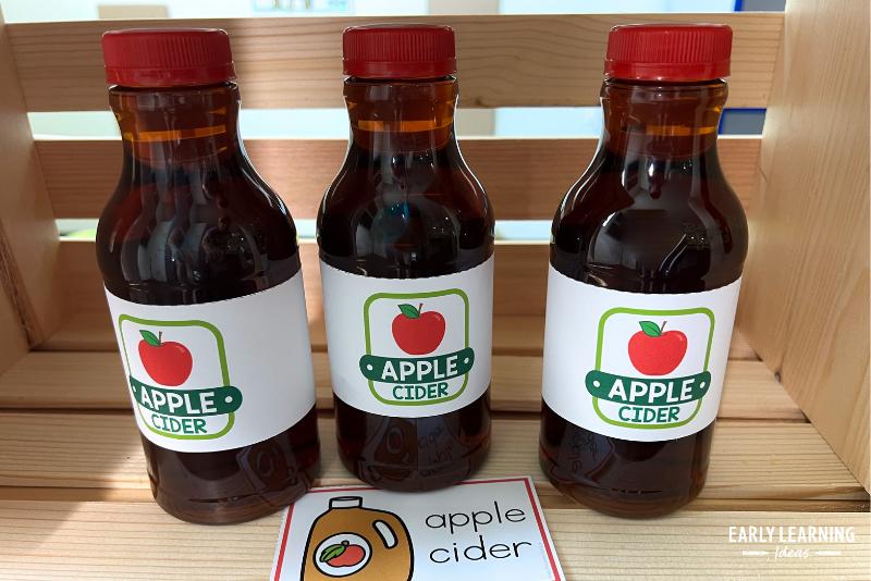 Pretend apple cider bottles in and apple stand dramatic play center