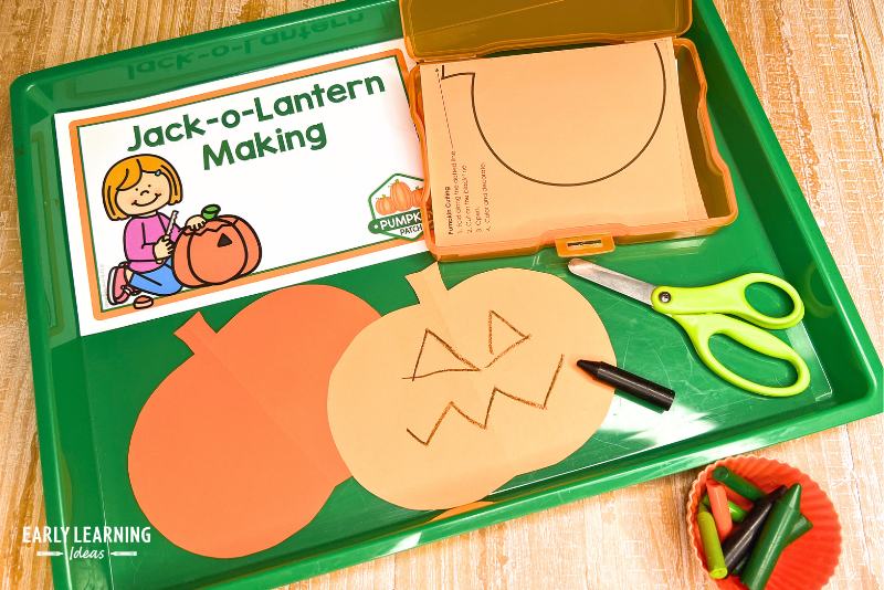 jack-o-lantern making - a paper pumpkin cutout with a face drawn on it.