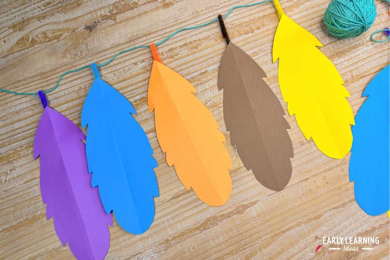 garland of paper feathers hung on string