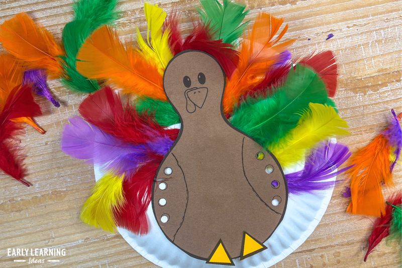 Paper plate Thanksgiving turkey craft with colorful feathers