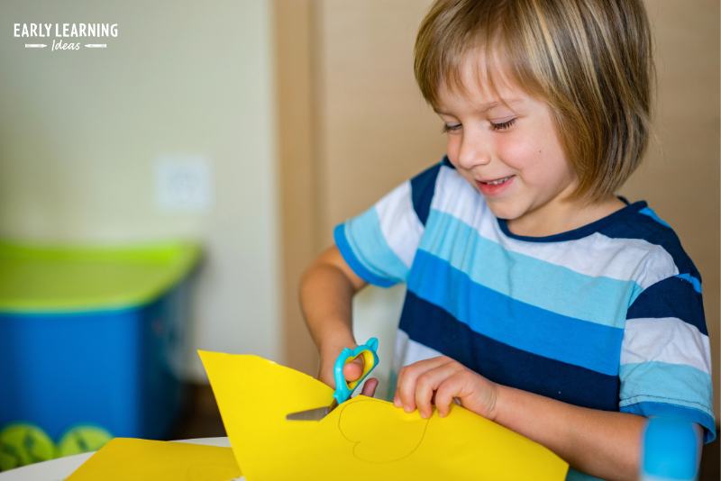 A child cutting yellow paper