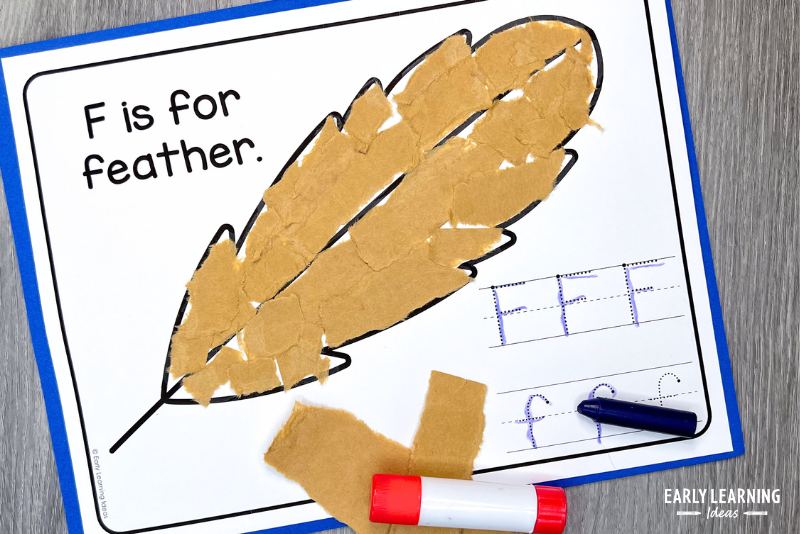 feather torn paper craft for the letter F with letter f tracing - shown with a glue stick and crayon
