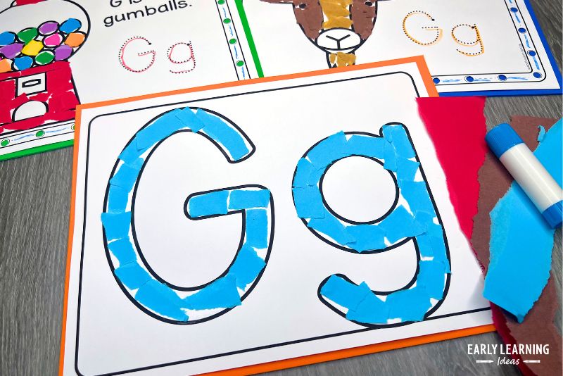 Letter G bubble letter craft shown with torn paper and glue stick.