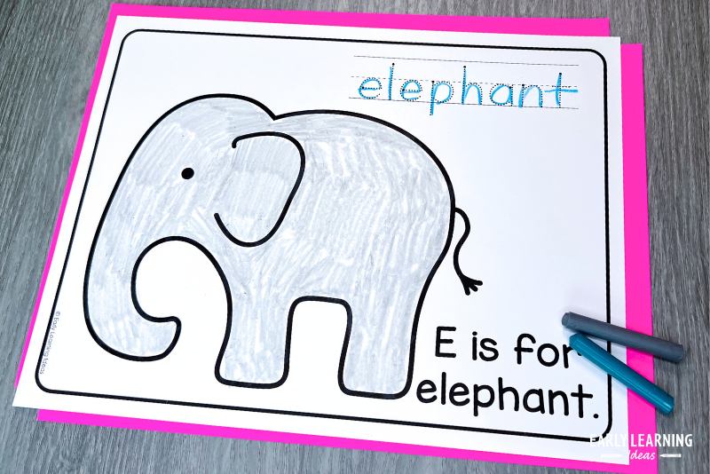 E is for elephant letter craft and coloring page shown with crayons