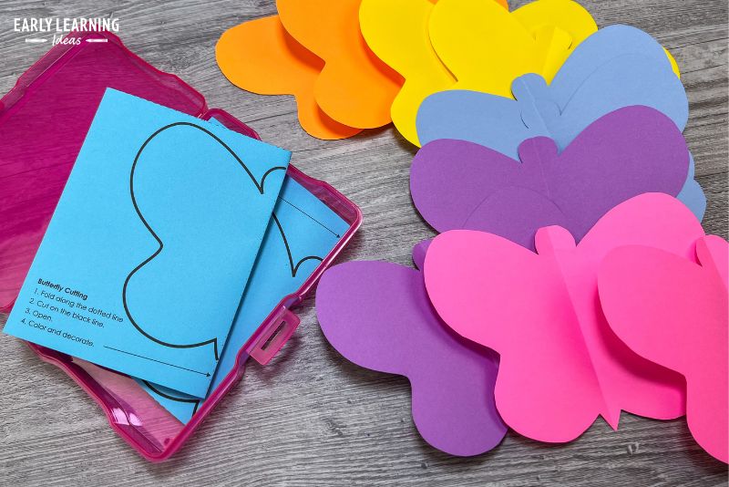 fold and cut butterfly activities in a task box with scissors