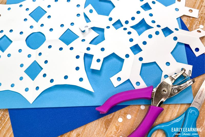 snow crafts for preschool and kindergarten kids - paper snowflakes with a hole punch