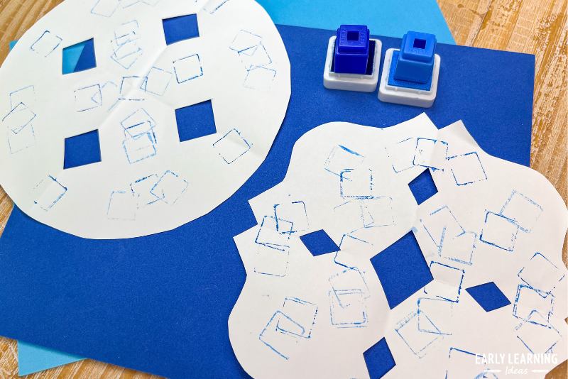 snowflake craft - paper snowflake stamped with unifix cubes
