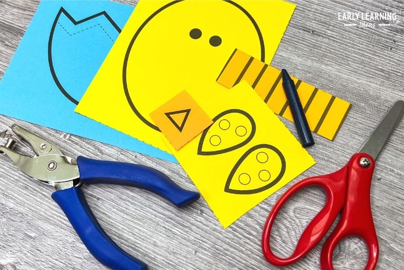 Easter crafts for preschoolers - A printable chick Easter fine motor craft with scissors, hole punch, and crayon.