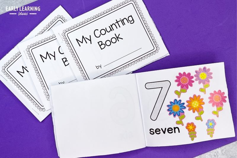 Printable counting book opened to the 7 page with 7 flower stickers