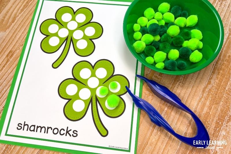 Shamrock dot coloring pages printed in full color and used with green pom-poms and tweezers for a fine motor activity